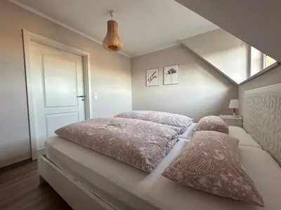 Ein Bett oder Betten in einem Zimmer der Unterkunft Ferienwohnung Oberförstchen