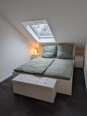 Ein Bett oder Betten in einem Zimmer der Unterkunft Ferienwohnung Am Stadtpark
