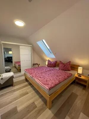 Ein Bett oder Betten in einem Zimmer der Unterkunft Ferienhaus Helfert FeWo2 mit eigener Terrasse