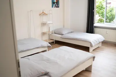 Ein Bett oder Betten in einem Zimmer der Unterkunft Design FerienOase mit Einzelbetten - 2 Schlafzimmer - Waschmaschine - Parkplatz