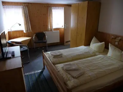 Ein Bett oder Betten in einem Zimmer der Unterkunft Erbgerichtsgasthof Holzhau