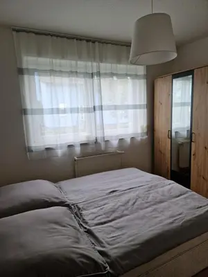 Ein Bett oder Betten in einem Zimmer der Unterkunft Kleine moderne Ferienwohnung