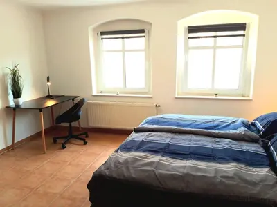 Ein Bett oder Betten in einem Zimmer der Unterkunft Seyfarthrooms - Ferienwohnung Zum Dorfladen Rathen - zentrale Lage mit direkter Anbindung an das Wanderwegenetz, moderne Inneneinrichtung