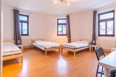 Ein Bett oder Betten in einem Zimmer der Unterkunft Perfekt für Gruppen mit Waschmaschine, Einzelbetten, Küche