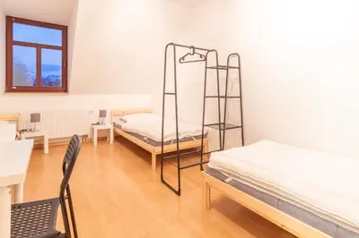 Ein Bett oder Betten in einem Zimmer der Unterkunft Perfekt für Gruppen mit Waschmaschine, Einzelbetten, Küche
