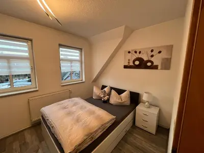 Ein Bett oder Betten in einem Zimmer der Unterkunft Ferienwohnung Mittweida-City 