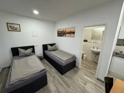 Ein Bett oder Betten in einem Zimmer der Unterkunft Pension Hertel
