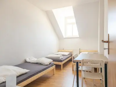 Ein Bett oder Betten in einem Zimmer der Unterkunft Einzelbetten, Waschmaschine, ideal für Gruppen