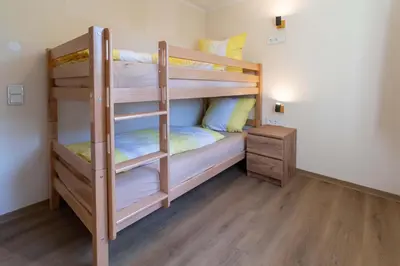 Ein Bett oder Betten in einem Zimmer der Unterkunft Ferienwohnungen im Waldhaus Sebnitz