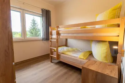 Ein Bett oder Betten in einem Zimmer der Unterkunft Ferienwohnungen im Waldhaus Sebnitz
