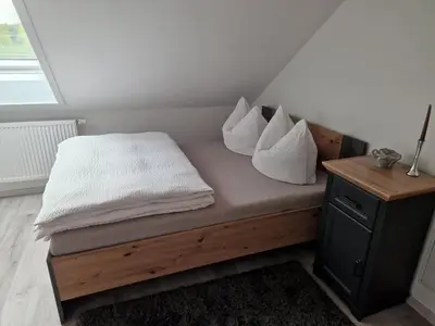 Ein Bett oder Betten in einem Zimmer der Unterkunft Moderne Ferienwohnung in Hainichen