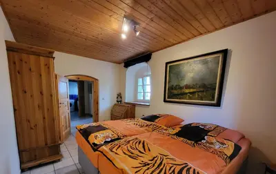 Ein Bett oder Betten in einem Zimmer der Unterkunft Ferienwohnung im Fachwerkhaus Maxen