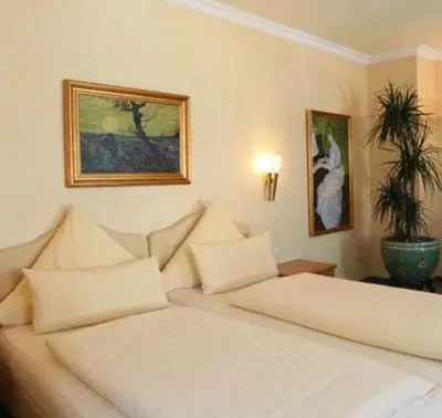 Ein Bett oder Betten in einem Zimmer der Unterkunft Pension am Großen Garten KG