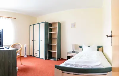 Ein Bett oder Betten in einem Zimmer der Unterkunft Landhotel Biberburg