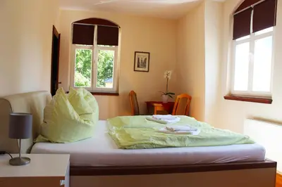 Ein Bett oder Betten in einem Zimmer der Unterkunft Ferienhaus Mühlberg
