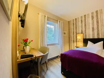 Ein Bett oder Betten in einem Zimmer der Unterkunft Hotel Zur Kutsche