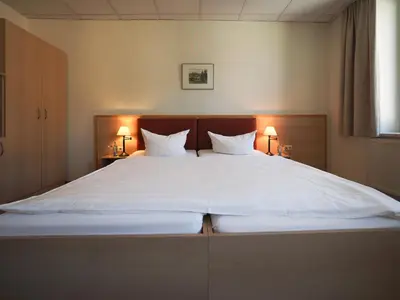 Ein Bett oder Betten in einem Zimmer der Unterkunft Gasthof Hillig