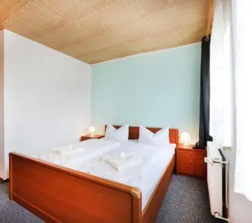 Ein Bett oder Betten in einem Zimmer der Unterkunft Hotel 