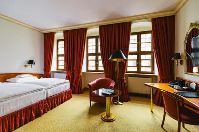 Ein Bett oder Betten in einem Zimmer der Unterkunft Romantik Hotel Bülow Residenz