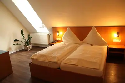 Ein Bett oder Betten in einem Zimmer der Unterkunft Hotel Folklorehof