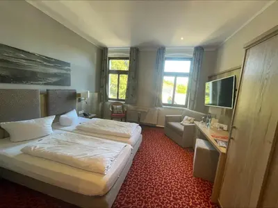 Ein Bett oder Betten in einem Zimmer der Unterkunft Parkhotel Margaretenhof