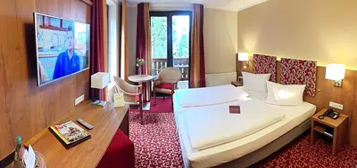 Ein Bett oder Betten in einem Zimmer der Unterkunft Parkhotel Margaretenhof