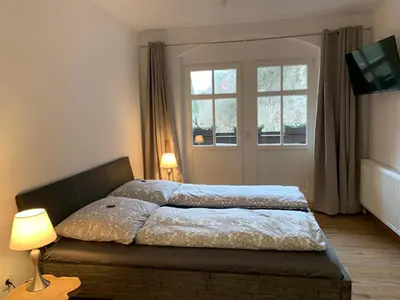 Ein Bett oder Betten in einem Zimmer der Unterkunft Ferienwohnungen Schweizerhaus