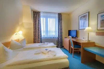 Ein Bett oder Betten in einem Zimmer der Unterkunft Hotel Alte Klavierfabrik Meißen