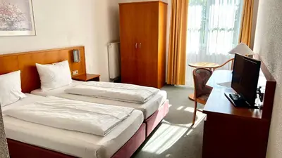 Ein Bett oder Betten in einem Zimmer der Unterkunft Hotel Siebeneichen