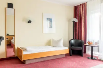 Ein Bett oder Betten in einem Zimmer der Unterkunft Andante Hotel Dresden