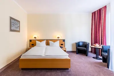 Ein Bett oder Betten in einem Zimmer der Unterkunft Andante Hotel Dresden