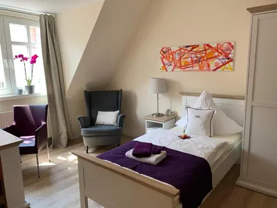 Ein Bett oder Betten in einem Zimmer der Unterkunft Gästehaus am Markt - Leisnig