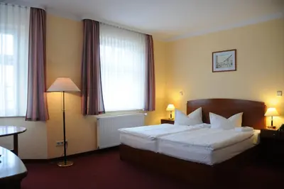 Ein Bett oder Betten in einem Zimmer der Unterkunft Hotel Döbelner Hof