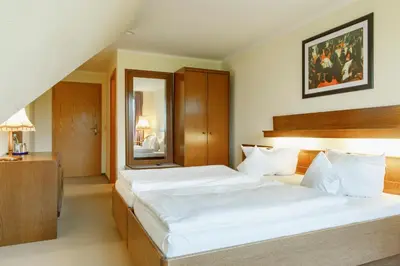 Ein Bett oder Betten in einem Zimmer der Unterkunft Eisenberger Hof