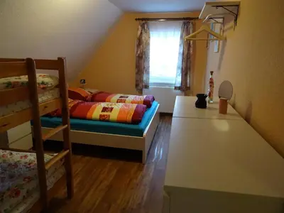 Ein Bett oder Betten in einem Zimmer der Unterkunft Ferienhaus Ferien am Waldrand