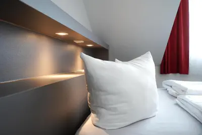 Ein Bett oder Betten in einem Zimmer der Unterkunft Aparthotel am Zwinger