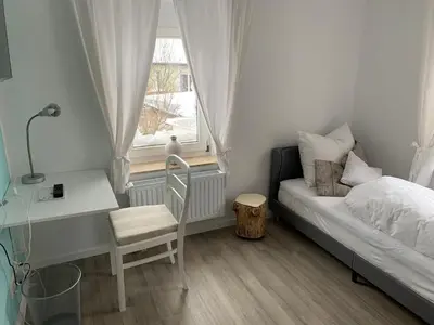 Ein Bett oder Betten in einem Zimmer der Unterkunft Pension Unikum Waldheim