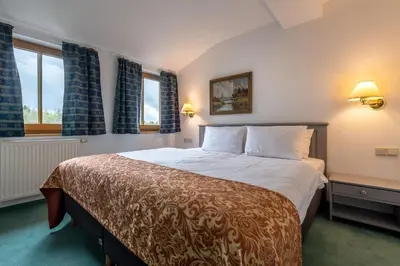 Ein Bett oder Betten in einem Zimmer der Unterkunft Parkhotel Hohnstein by STEIGER Hotels