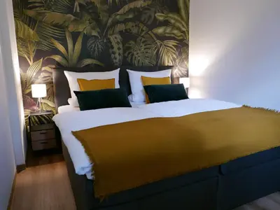 Ein Bett oder Betten in einem Zimmer der Unterkunft Ferienwohnung Dresden-Pillnitz - Elbhang-Villa - 