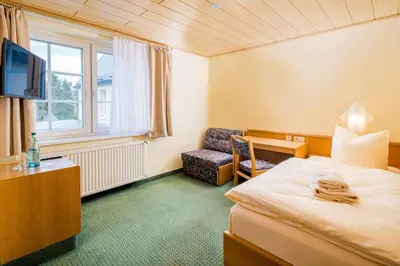 Ein Bett oder Betten in einem Zimmer der Unterkunft Landhaus Purschenstein