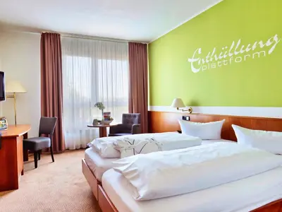 Ein Bett oder Betten in einem Zimmer der Unterkunft Hotel Sportwelt Radeberg
