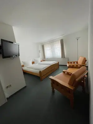 Ein Bett oder Betten in einem Zimmer der Unterkunft Hotel Garni „zum Bären“
