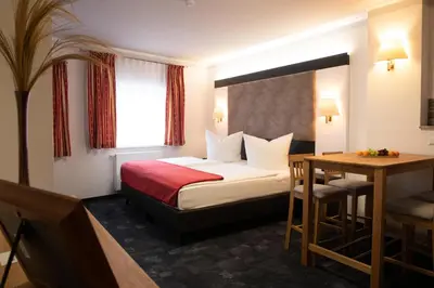 Ein Bett oder Betten in einem Zimmer der Unterkunft Hotel zur Kulturweberei