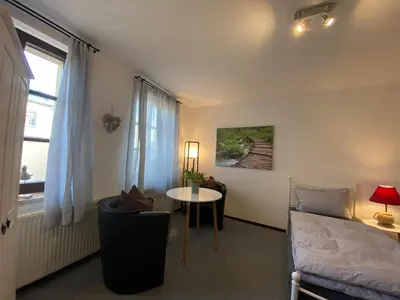 Ein Bett oder Betten in einem Zimmer der Unterkunft Fewo Sachsenhöhe