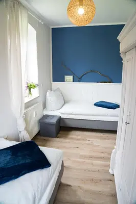 Ein Bett oder Betten in einem Zimmer der Unterkunft Urlaubsfreude Biedermann Haus GlücksStein Ferienwohnung Saphir
